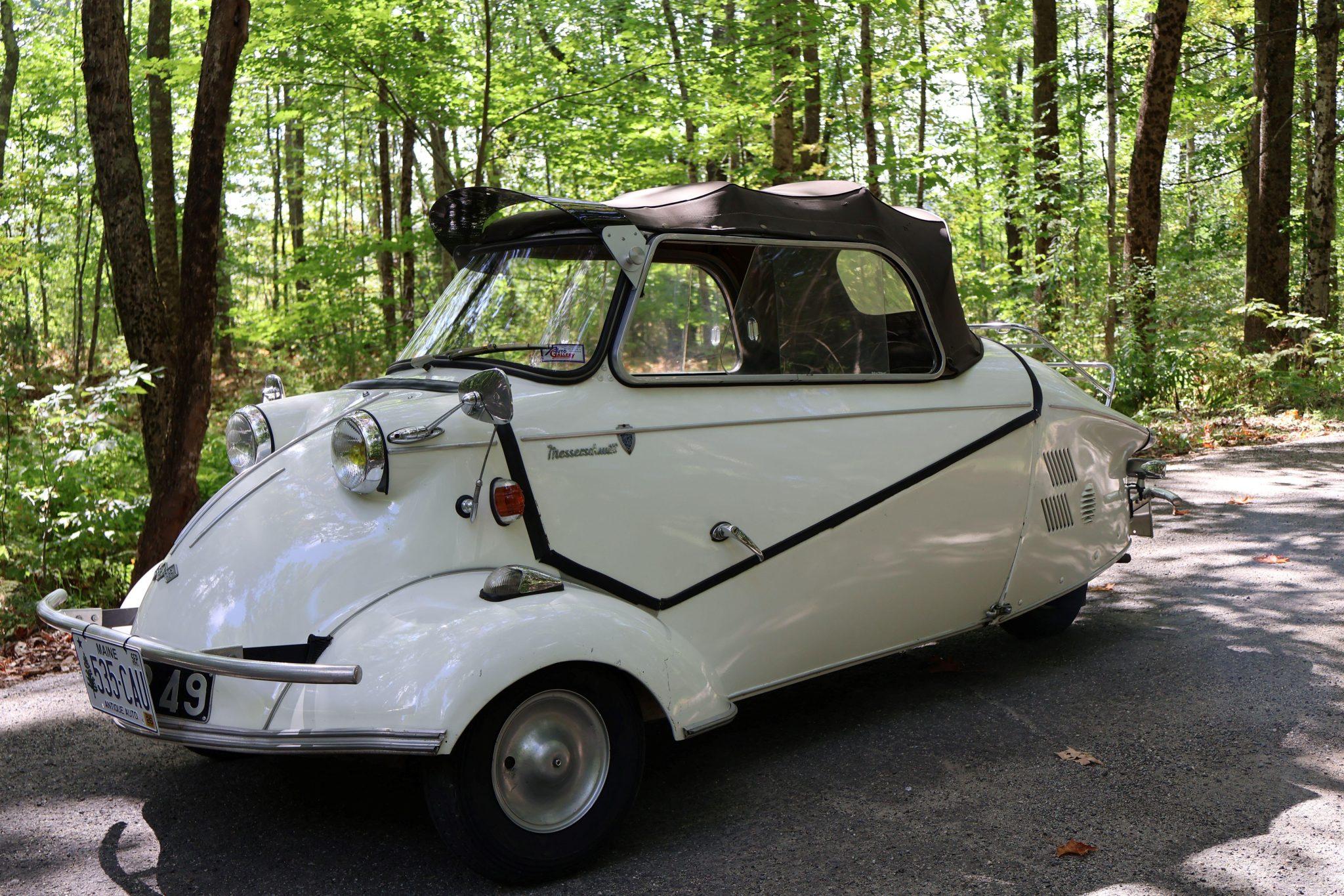 This 1963 Messerschmitt KR200 is said to have been first registered in France before being imported to the US and placed on display in the Bruce Weiner Microcar Museum. It was listed on BaT in February 2022 by its prior owner of 12 years, and it was subsequently acquired by the seller in March 2025. Work in preparation for the sale has included cleaning the carburetor, flushing the fuel tank, adjusting the clutch cable, fitting an inline fuel shut-off valve, repairing the horn and brake light wiring and replacing the fuel hoses, battery, horn, and leather canopy strap. The white over black convertible is powered by an air-cooled 191cc two-stroke single mated to a four-speed manual transmission and features CoCo floor mats, a black convertible soft top, a tinted windshield visor, a rear luggage rack, seating for three, a motorcycle-style handlebar, and sliding side windows.