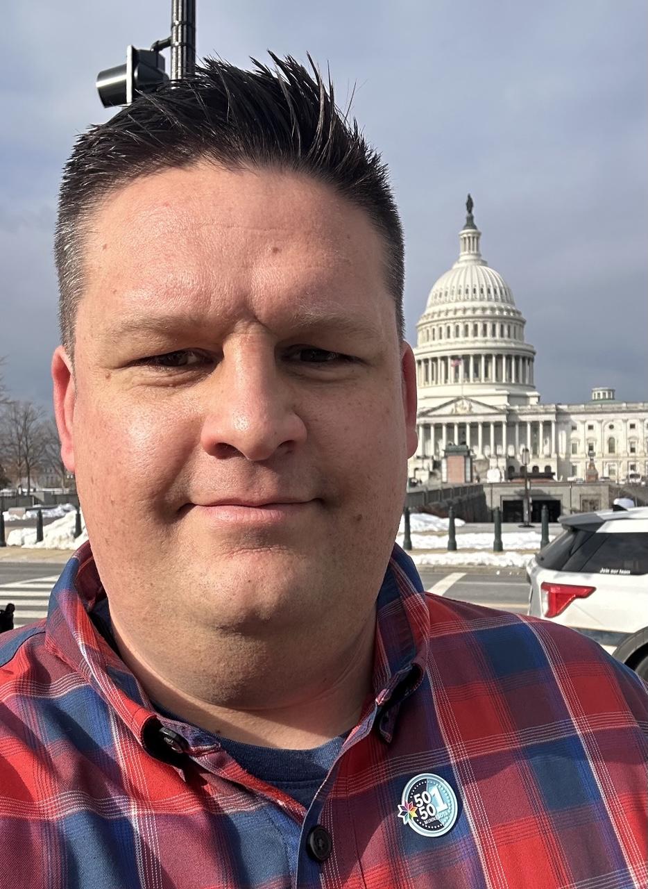 An affable doofus in front of the US Capitol
