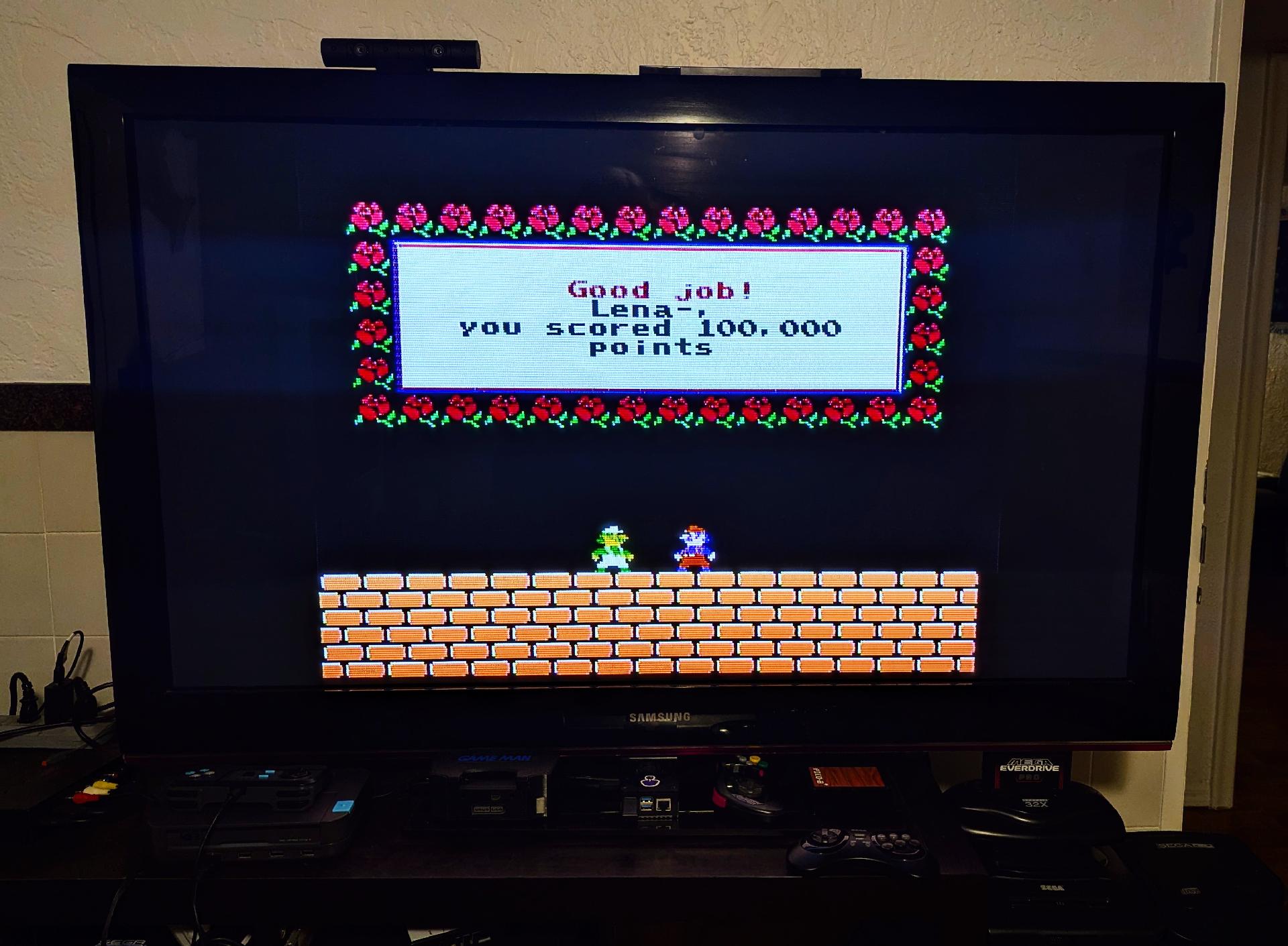 A picture of the game in my TV at a special screen that reads "Good Job, Lena - you scored 100,000 points!"