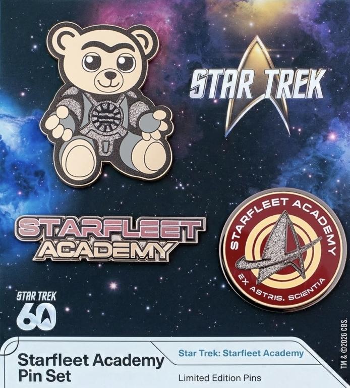 Official star trek Starfleet Academy pin set. The Teddy Bear the little boy was clutching in EP. 1, one saying Starfleet academy and one of the round red yellow insignia (frosted delta with ring around it) with school motto Ex Astris, Scientia