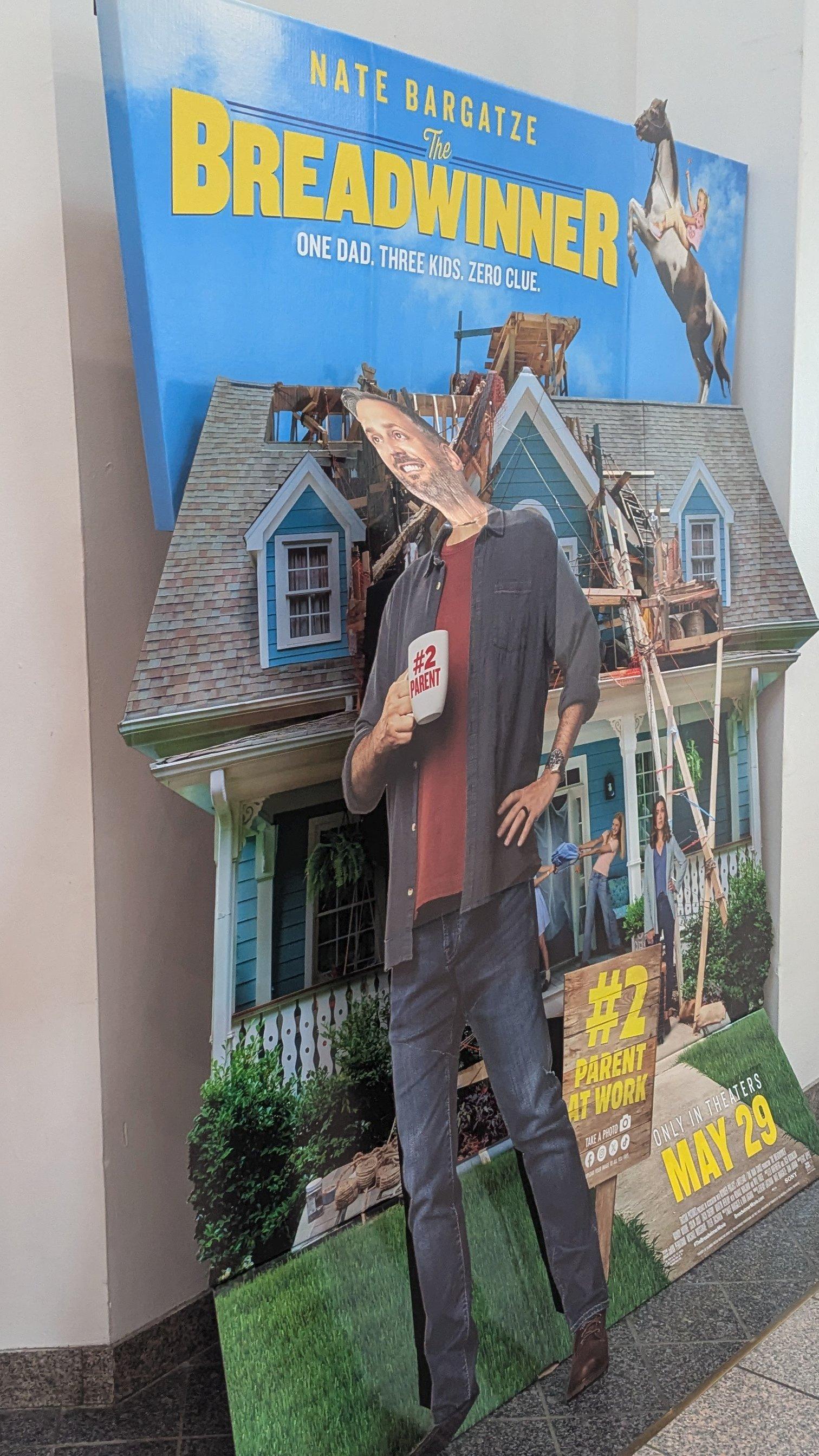 Same standee, whose head it turns out was not ripped off but just folded back out of sight. Now it's back in view, but at an angle more characteristic of corpses with broken necks.