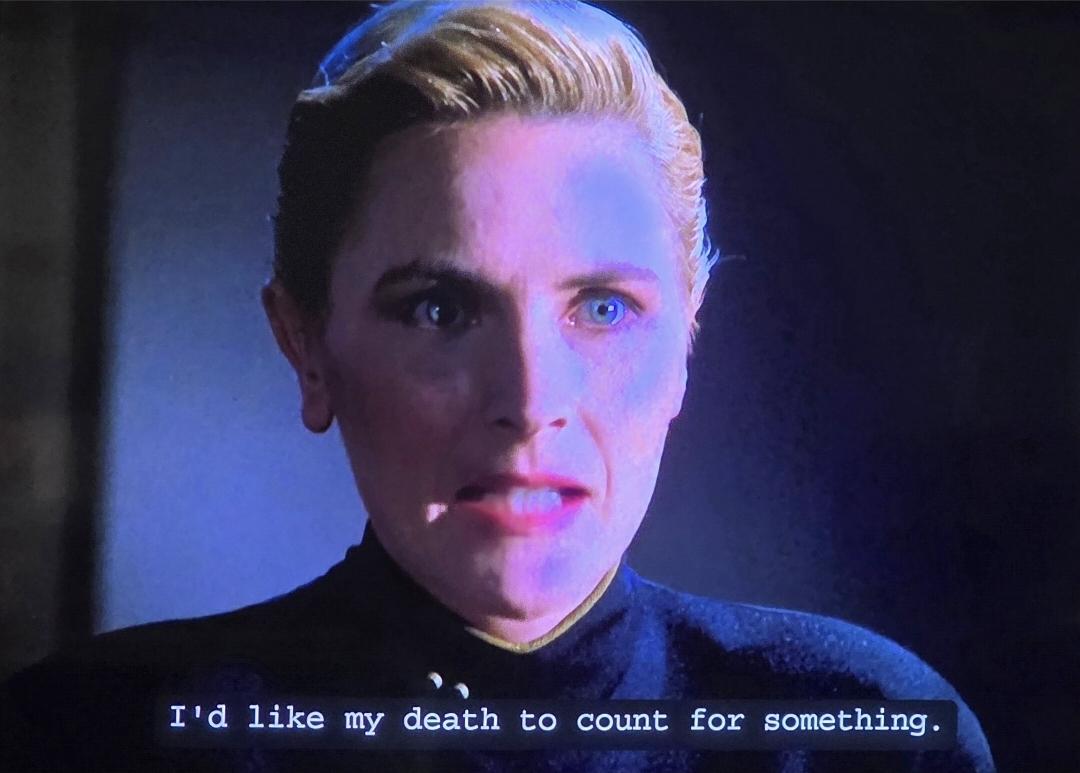 Tasha Yar in Yesterday's Enterprise. Her short blond hair is combed back. She's just asked Picard for permission to go serve on the 1701-C. She explains, "I'd like my death to count for something."