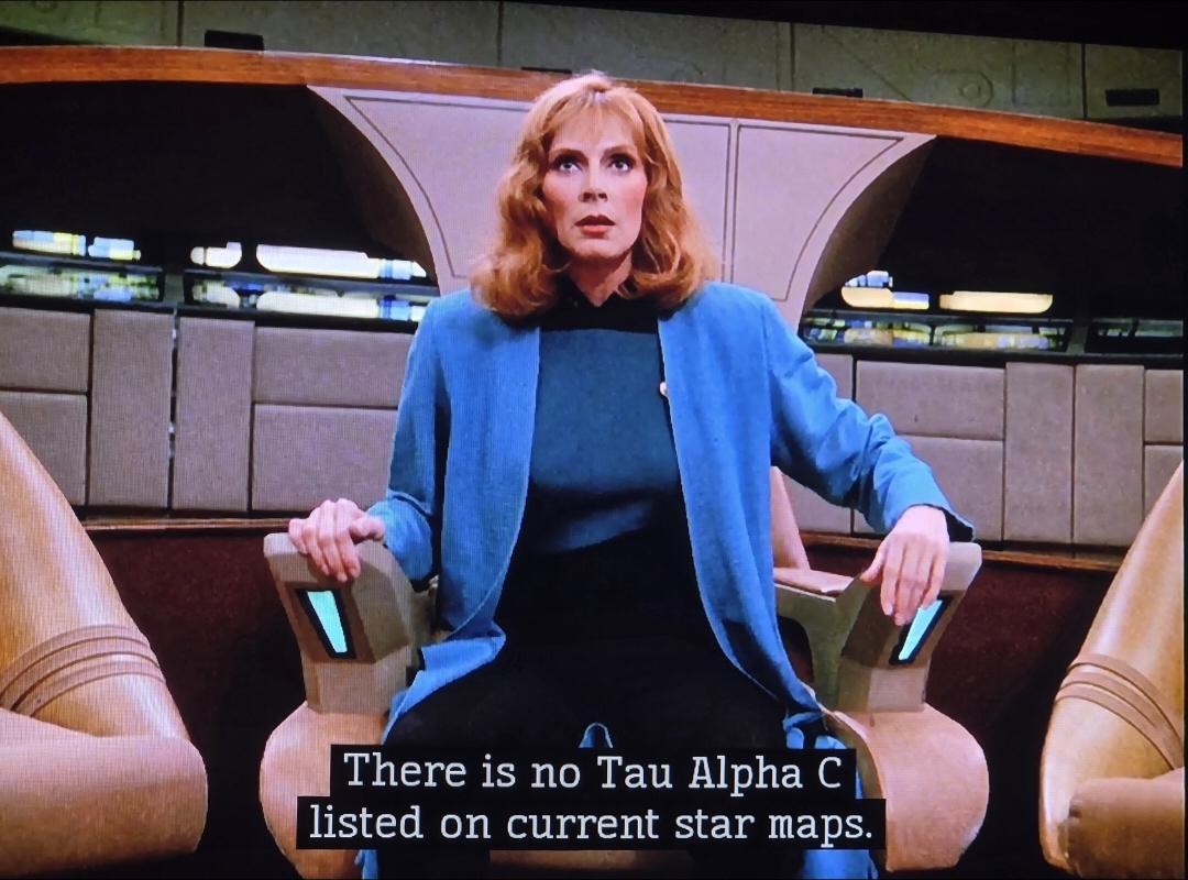 Dr. Crusher sitting in the Captain's chair on the bridge all alone. The computer has just told her There is no Tau Alpha C listed on current star maps. She looks like she's ready to lose it.