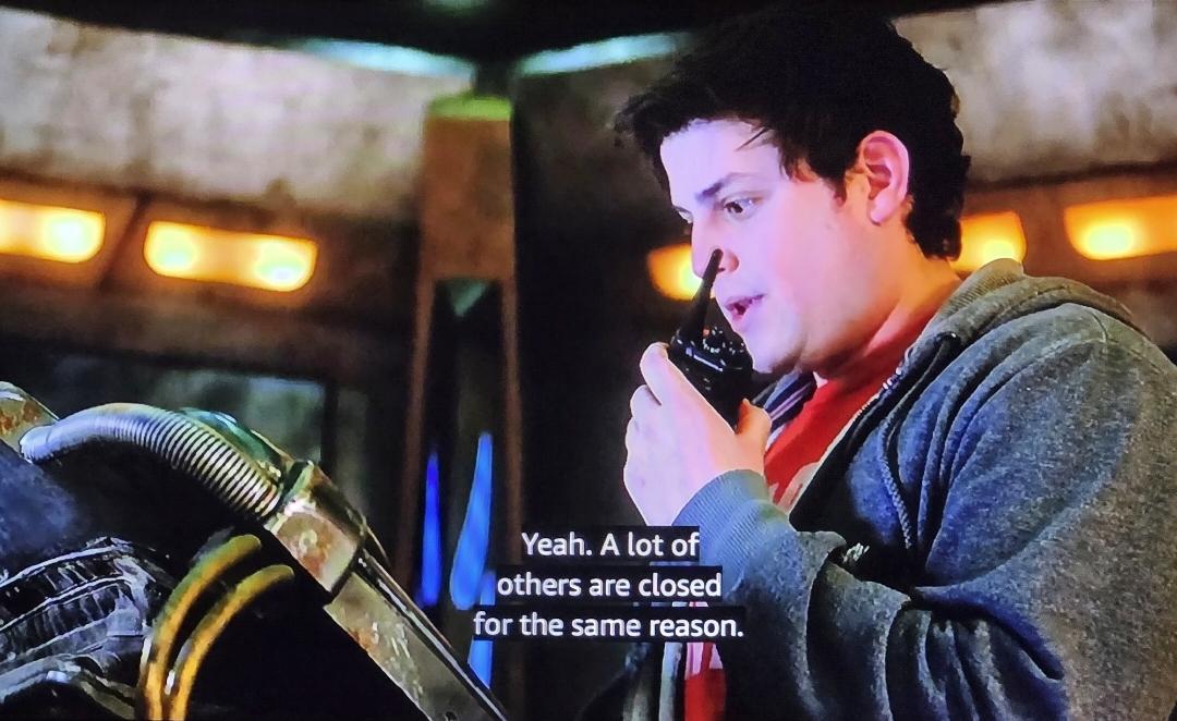 David Blue as Eli Wallace on a grungy alien spaceship trying to figure out how to get life support back online. He's speaking on a walkie talkie saying: Yeah. A lot of others are closed for the same reason.