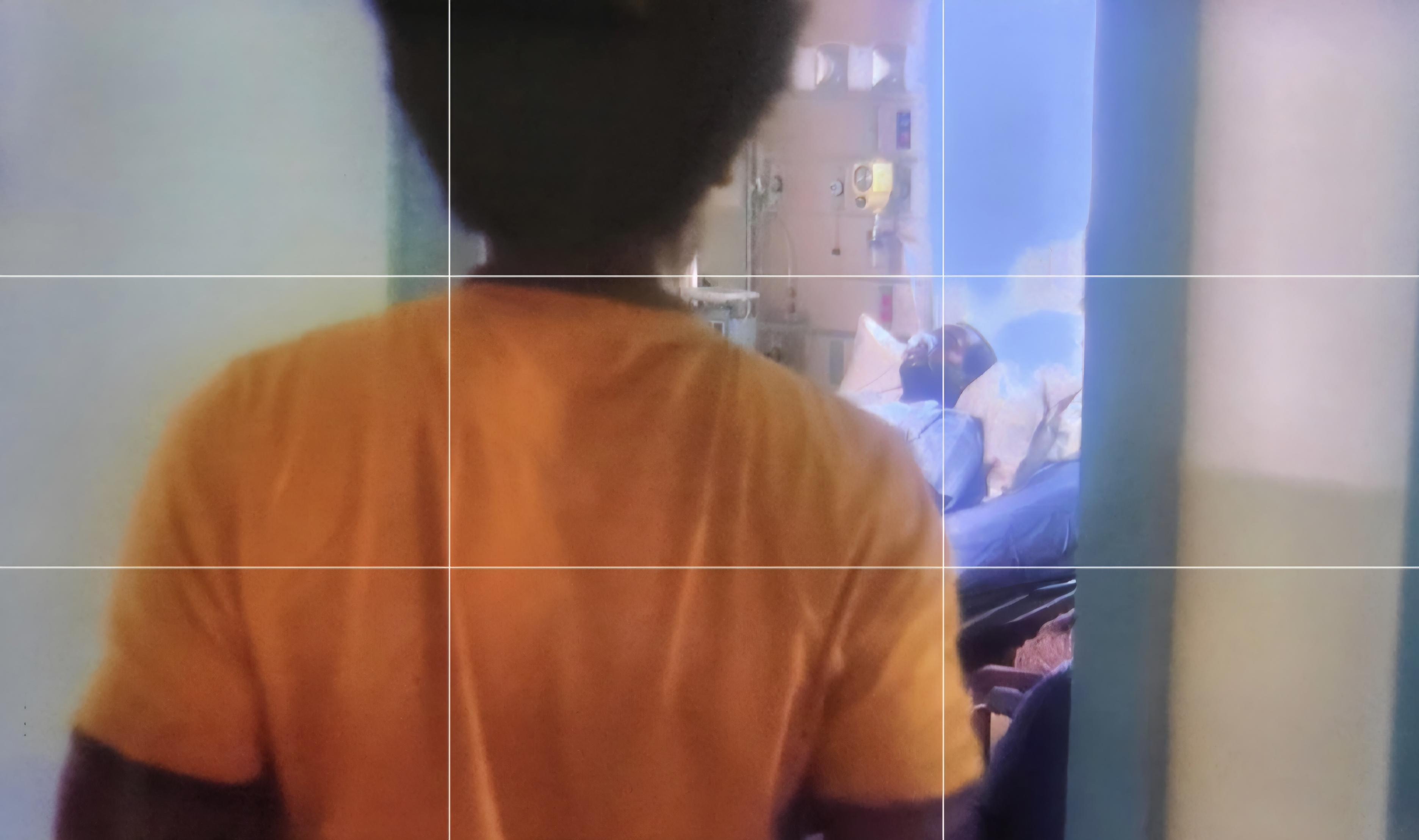 A child enters his sick father's hospital room. Dad has oxygen attached to him.