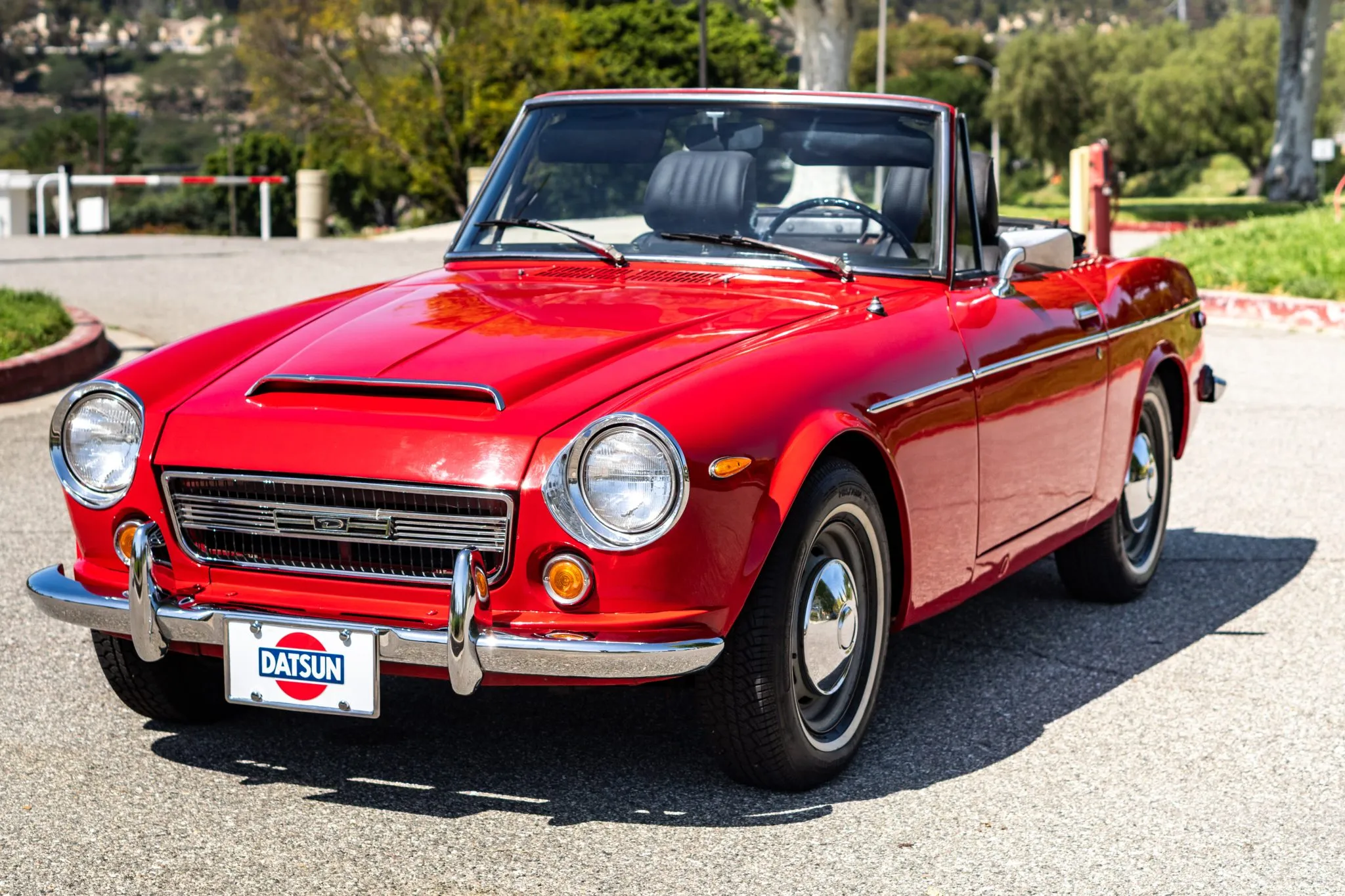 This 1969 Datsun 2000 roadster is believed to have spent most of its time in California, and it underwent refurbishment work following the seller’s 2016 acquisition that included an exterior repaint and an overhaul of the interior. The car is finished in red over black upholstery, and power is provided by a 2.0-liter inline-four equipped with dual side-draft carburetors and linked to a five-speed manual transmission. Features include a black convertible top, chrome-finished bumpers and trim, a hood scoop, a driver-side mirror, and 14” steel wheels as well as a heater and an AM radio.