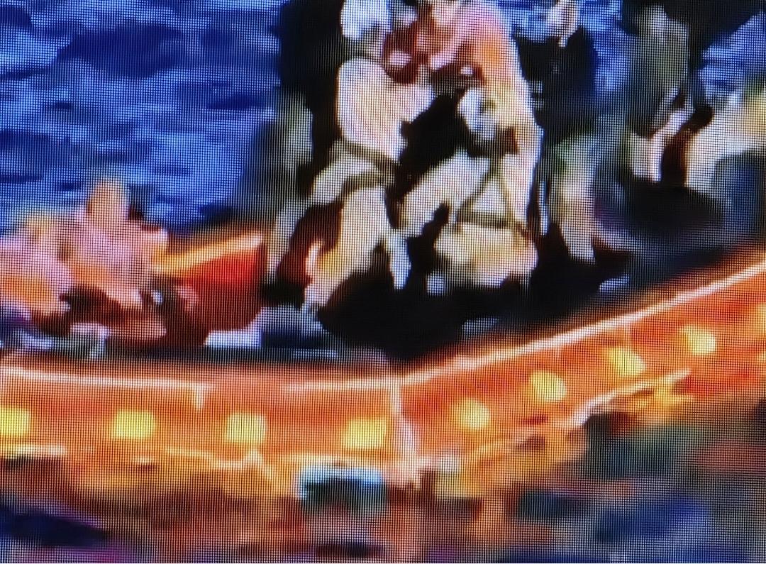 Super blurry picture of the astronauts in tangerine, two seated.