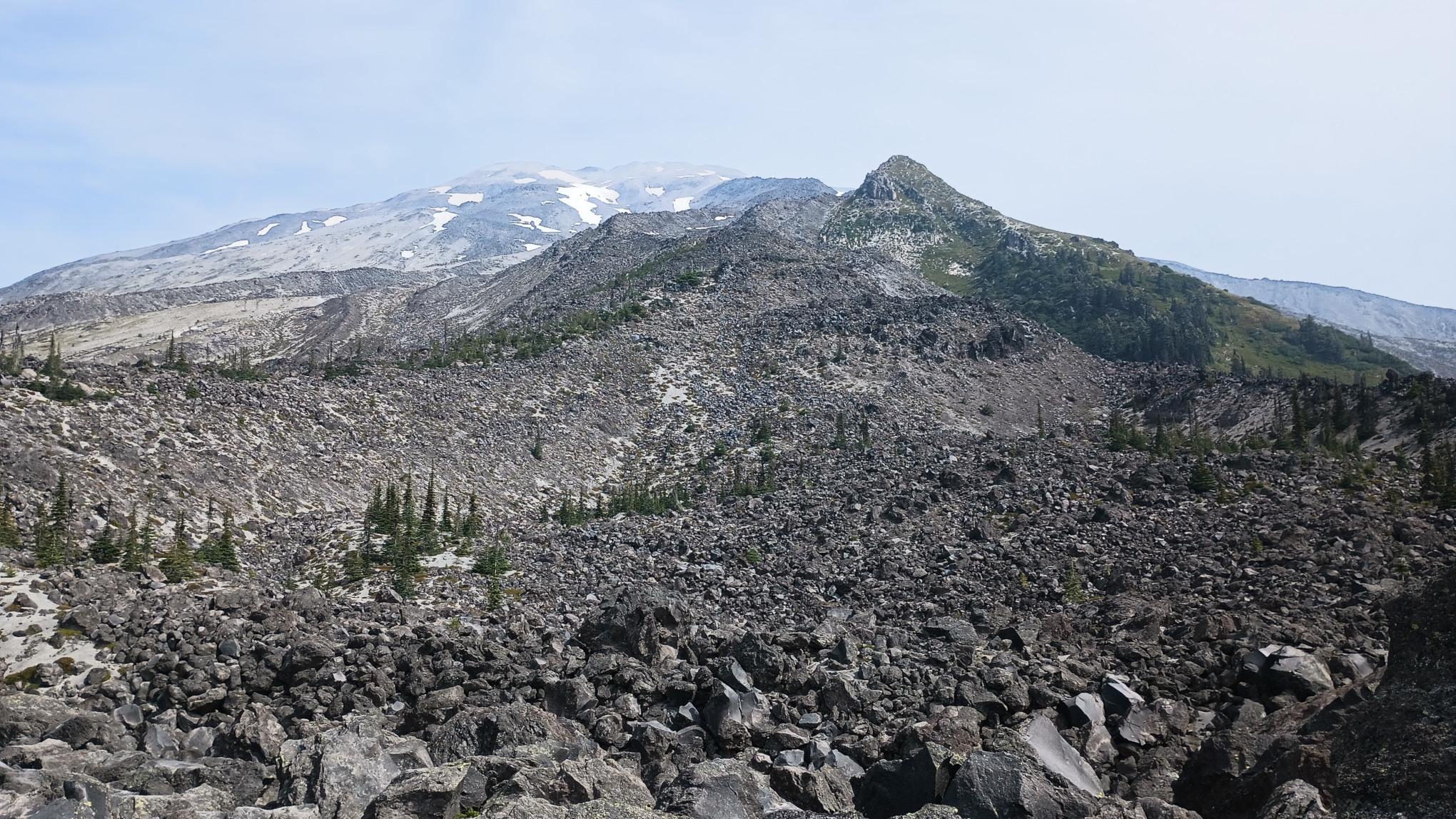 A shot of Loowit looking mostly bare of snow. A huge field of dark boulders covers this side of the mountain.